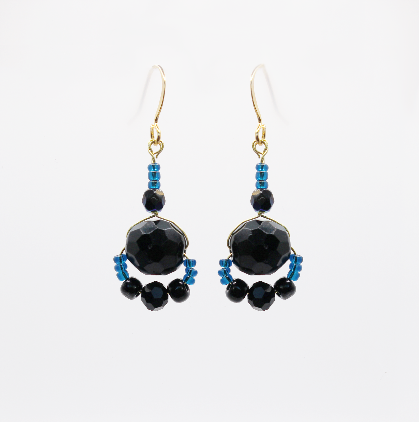 Handmade black and blue earrings with tiny midnight blue beads and faceted black glass.
